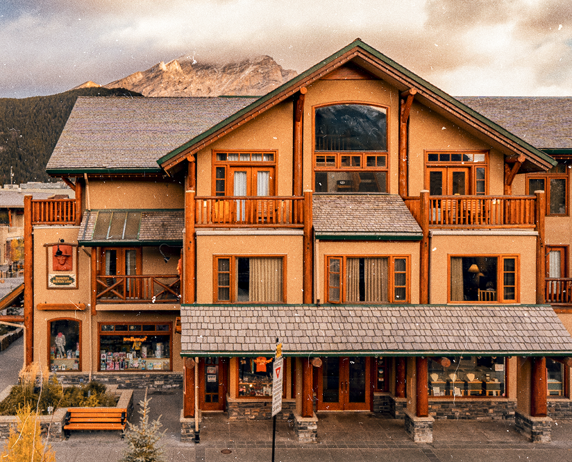 Front exterior of Brewster Mountain Lodge in downtown Banff with mountain backdrop